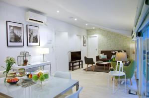 a living room with a dining table and a living room at Feelathome Madrid Suites Apartments in Madrid