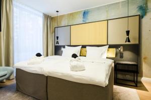 En eller flere senger på et rom på Hotel Sveitsi