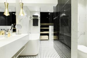 a bathroom with a shower and a toilet and a sink at Hotel Sveitsi in Hyvinkää