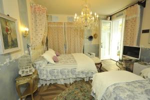 Un pat sau paturi într-o cameră la B&B La Maison degli Angeli