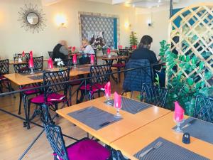 a restaurant with tables and chairs with pink candles on them at Hôtel Sampiero in Bastia