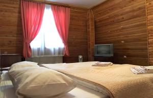Postel nebo postele na pokoji v ubytování Motel Karpaty