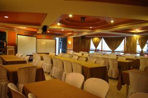 a conference room with tables and chairs and a whiteboard at Elegant Circle Inn in Cebu City