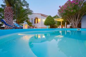 a swimming pool in front of a house at Villa Ginestra - Scopello-Villas in Scopello +13 photos