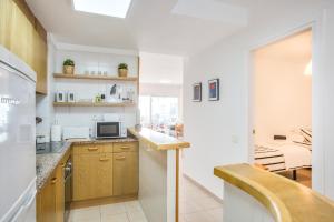 A kitchen or kitchenette at Lets Holidays White apartment with terrace, ac & parking, near beach