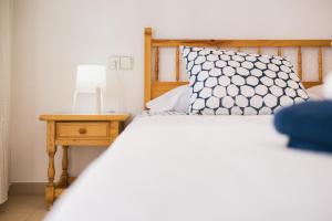 A bed or beds in a room at Lets Holidays White apartment with terrace, ac & parking, near beach