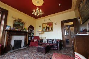 a living room with a couch and a fireplace at Fort William Backpackers in Fort William
