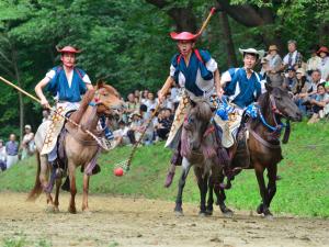 a group of men playing a polo game on horses at Smile Hotel Hachinohe in Hachinohe