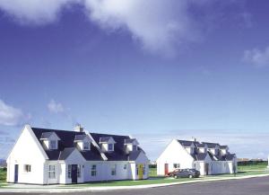 a row of houses with a car parked in front at Ballybunion Holiday Cottages in Ballybunion