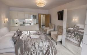 a bedroom with a bed and a living room at Apartmany U Jezka in Ždiar