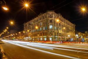 a city street at night with a building and street lights at Ekspo-Hotel in Saint Petersburg