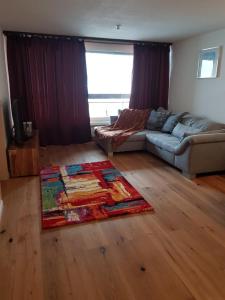 a living room with a couch and a rug at Ferienwohnung Alpenblick in Davos