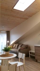 a living room with a couch and a table at Malūno Vilos apartamentai centre in Palanga