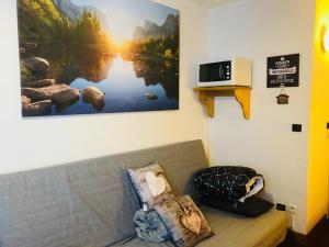 a couch in a room with a picture on the wall at Les deux Alpes studio in Les Deux Alpes