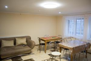 a living room with a couch and a table at Імобільяре in Khorostkiv
