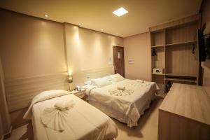Llit o llits en una habitació de Hotel London Santarem
