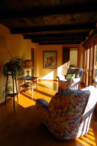 a living room with two chairs and a table at Agriturismo Oro di Berta in Portula