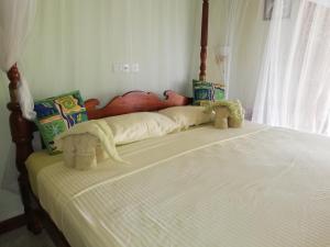two stuffed animals sitting on top of a bed at Mahi Villa in Bentota