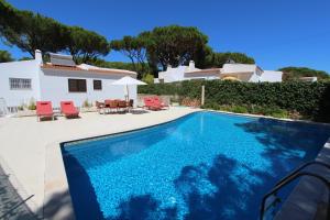 a villa with a swimming pool and a house at Villa Violeta 51 - Clever Details in Vilamoura