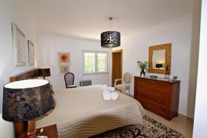 a bedroom with a large bed and a dresser at Villa Violeta 51 - Clever Details in Vilamoura +25 photos