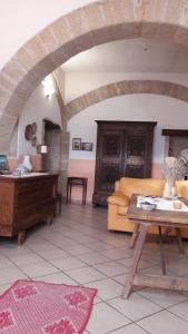 a living room with a couch and a table at La Casa Rossa in Riola Sardo