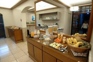 a buffet in a kitchen with food on it at Hotel São Marcos in São Marcos +18 photos