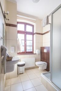 Baño blanco con lavabo y aseo en Resursa, en Żyrardów