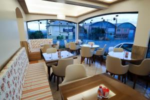 a restaurant with tables and chairs and a large window at Hotel São Marcos in São Marcos