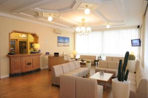 a waiting room with couches and chairs and a table at Hotel dell'Amarissimo in Bellaria-Igea Marina