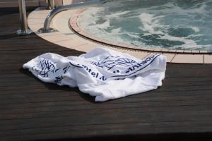 a towel on the floor next to a swimming pool at Hotel dell'Amarissimo in Bellaria-Igea Marina