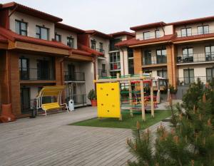 a playground in the courtyard of a apartment building at Malūno Vilos apartamentai centre in Palanga