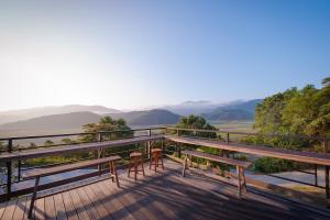 a deck with benches and a view of the mountains at Sun Hola Villa in Datong