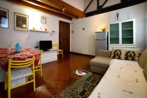a living room with a couch and a table at Holiday Treviso Suite LOMBARDI in Treviso
