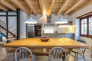 a kitchen with a large wooden table and chairs at Lets Holidays Fisherman House in Tossa de Mar