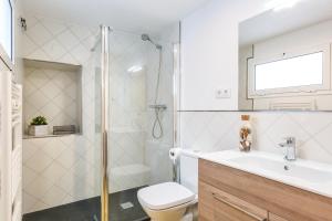 a bathroom with a shower and a toilet and a sink at Lets Holidays Fisherman House in Tossa de Mar