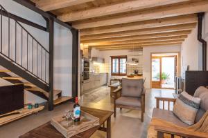 a living room with a staircase and a kitchen at Lets Holidays Fisherman House in Tossa de Mar