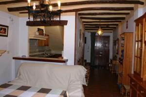 a living room with a bed and a kitchen at Casa De La Ermita in Bubión