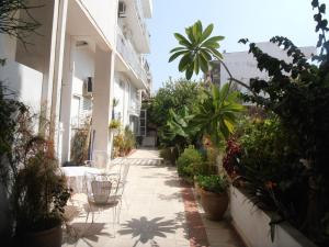 a courtyard of a building with potted plants at Diana Rooms in Chania