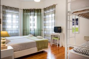 a bedroom with a bed and a bunk bed at Loulé Coreto Hostel in Loulé