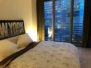 a bedroom with a bed and a large window at Suite im Sony Center am Potsdamer Platz in Berlin