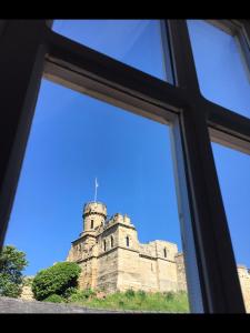 a view of a castle through a window at Castle View Cottage in Lincoln