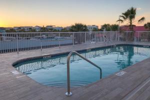 a swimming pool with a hand rail in a resort at The Palms Oceanfront Hotel in Isle of Palms