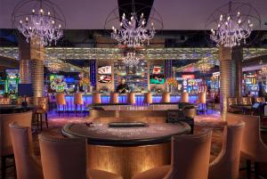 a bar at a casino with chandeliers at Downtown Grand Hotel & Casino in Las Vegas