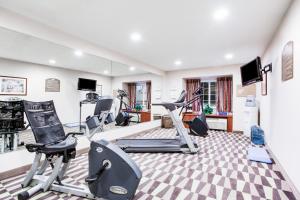 a gym with treadmills and cardio equipment in a room at Microtel Inn & Suites by Wyndham Olean in Olean