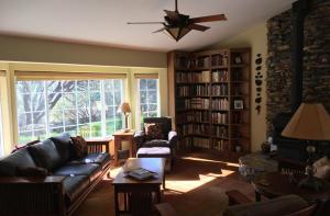 a living room with a couch and bookshelves at Foxtail Farm Bed & Breakfast in Ponderosa Basin