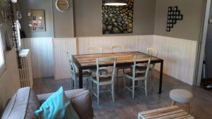 a dining room with a table and chairs at la maison du postier in Port-en-Bessin-Huppain