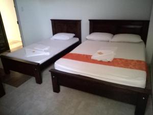 Postel nebo postele na pokoji v ubytování Aparta Hotel El Cacique Upar