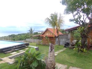 a resort with a swimming pool and a house at Green Bowl Beach Villas in Uluwatu