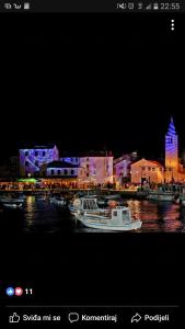 a boat is docked in a harbor at night at Apartment Ivica in Fažana