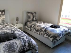 a bedroom with two beds and a window at Bel et spacieux appartement de 84 m² avec parking très proche du Métro Garibaldi in Lyon